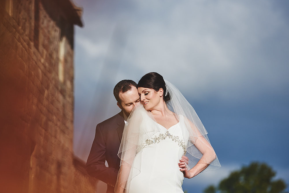 Groom kissing brides neck
