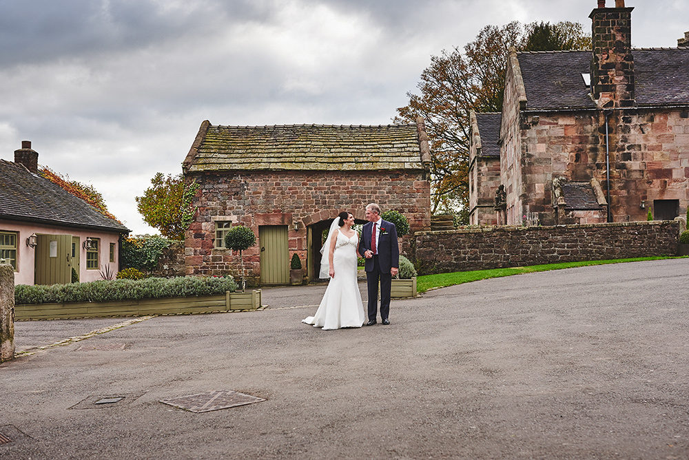 The bride and her dad coming across The Ashes courtyard