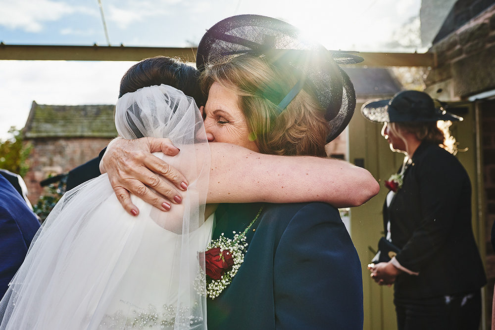 Mum hugs her daughter after getting married at The Ashes wedding venue