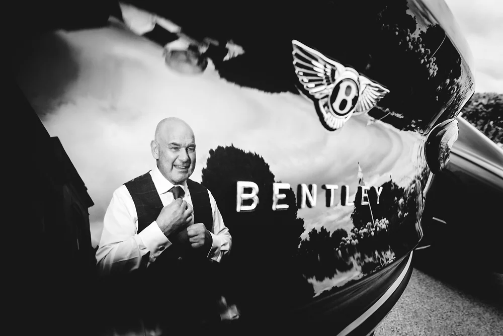 Shrigley Hall Macclesfield Wedding Photographer - Groom getting ready reflection in Bentley