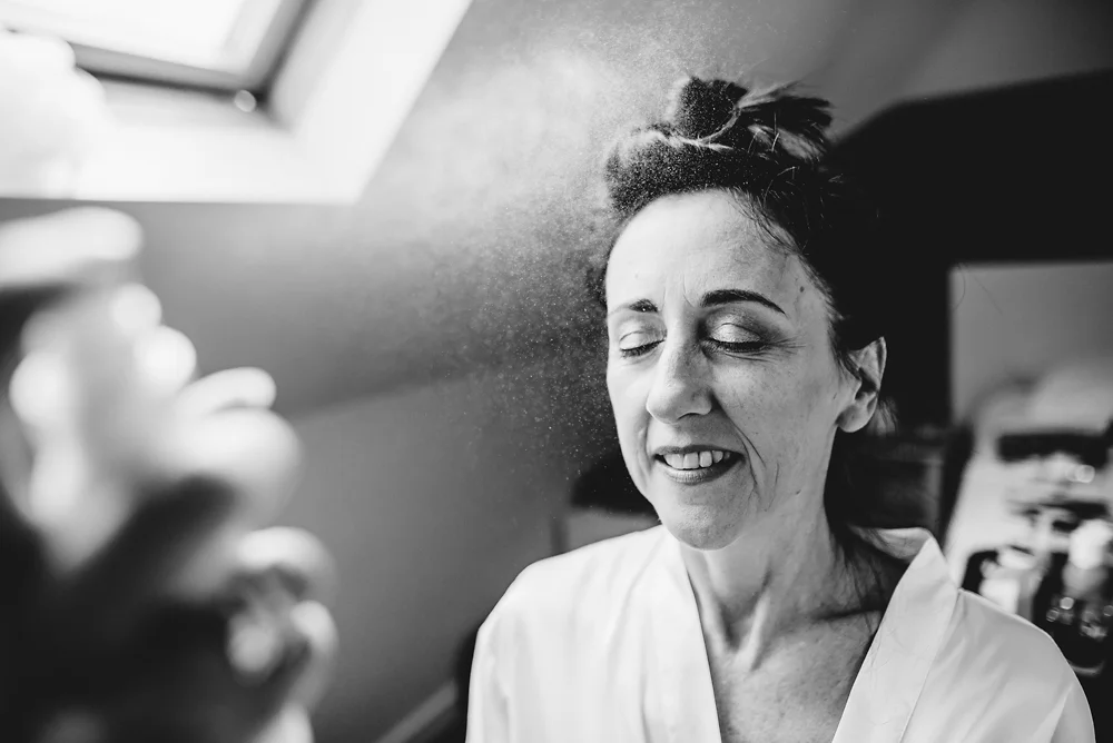 Shrigley Hall Macclesfield Wedding Photographer - Bride having fixing spray applied