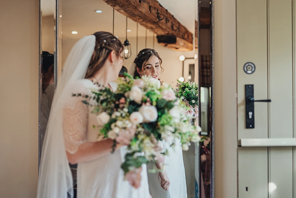 The Bride looks over herself before the ceremony at The Ashes Barns Staffordshire