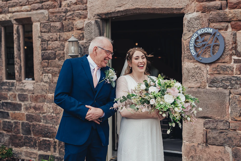 Bride and father having a laugh before the ceremony at The Ashes Barns in Staffordshire
