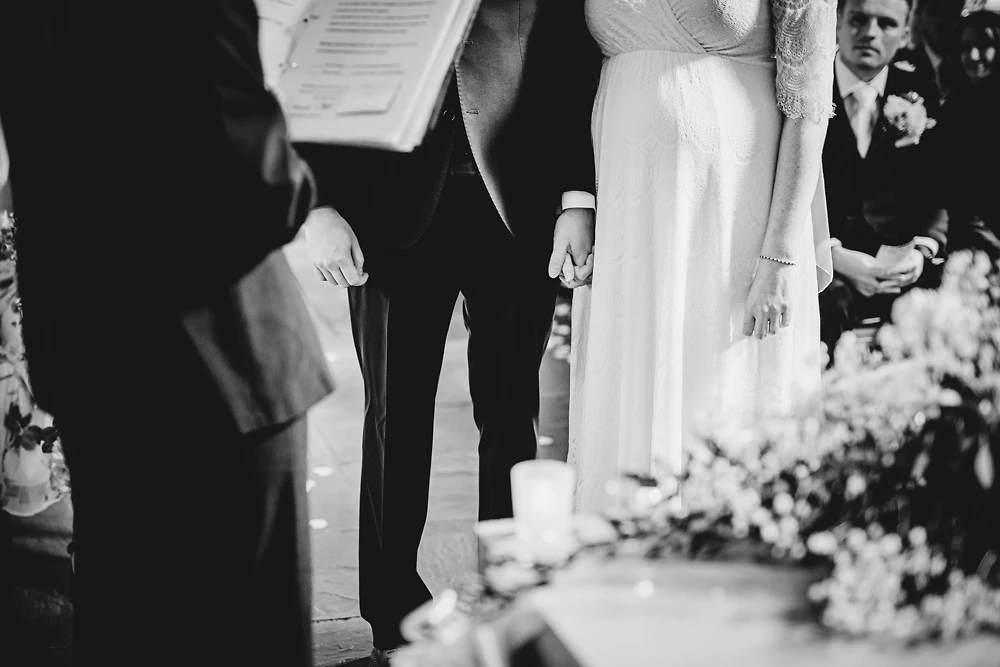 Bride & groom hold hands during the ceremony at The Ashes Barns Staffordshire