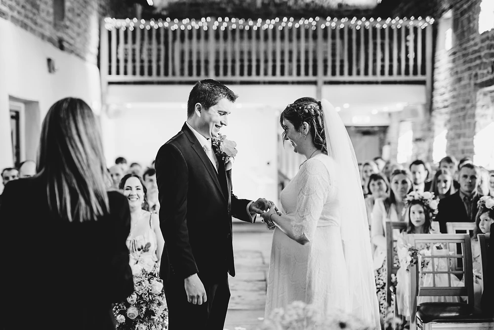 Bride & groom exchange rings during the ceremony at The Ashes Barns Staffordshire