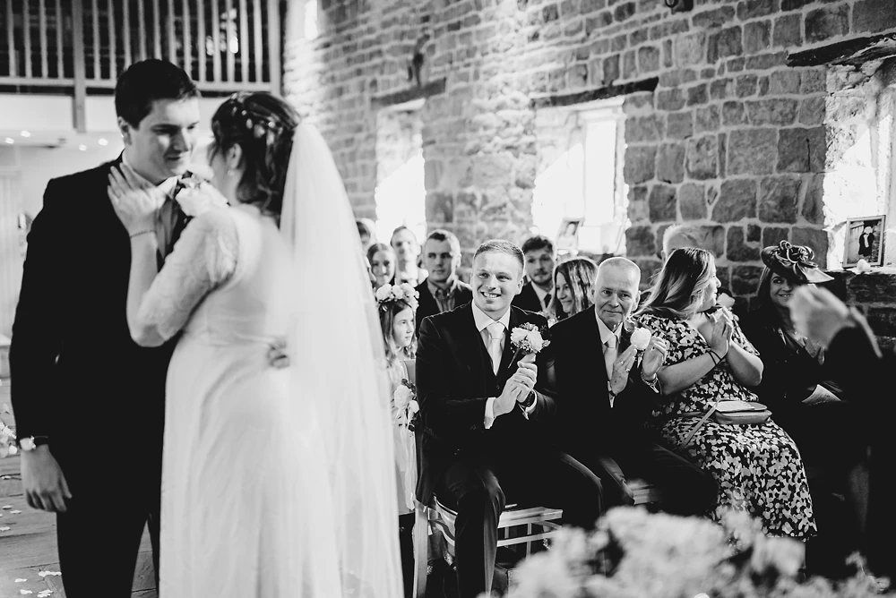 Family applaud the bride and groom after the ceremony at the Ashes Barns Staffordshire