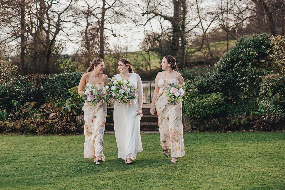 Bride and her bridesmaids walking in the garden at The Ashes Barns Staffordshire