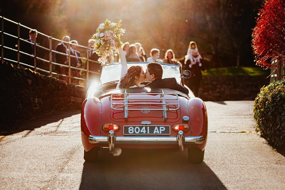 Couple arrive at The Ashes Barns in a MG sports car