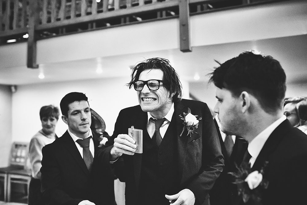 Usher drinking from hip flask - wedding